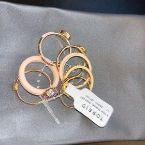 Pink and gold tone enamel set of seven rings